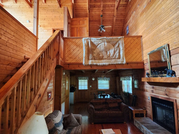 the staircase to a second floor room is above a couch and chair