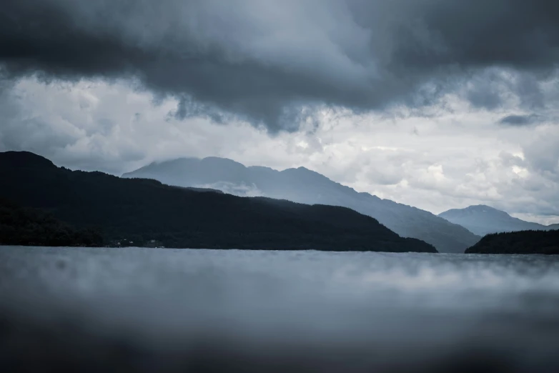 a body of water under a cloudy sky