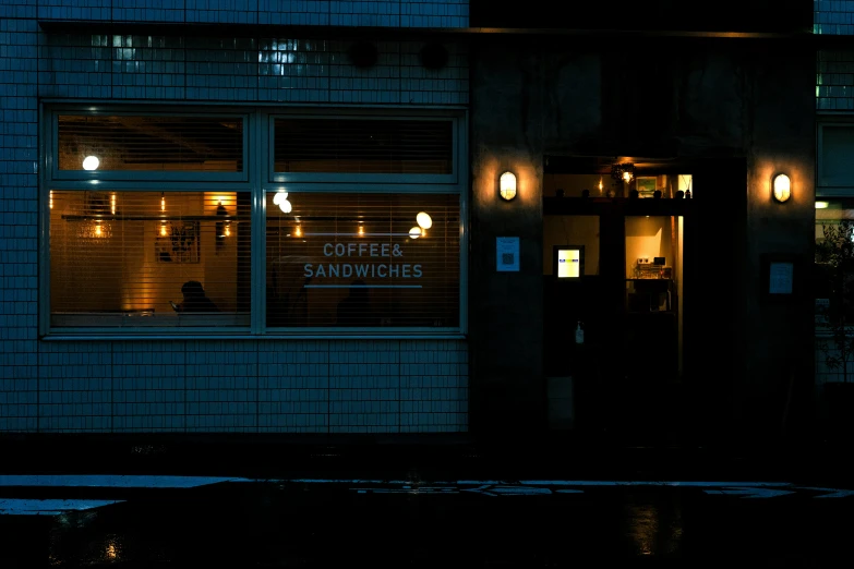 a dark night scene of a building with lights outside of it