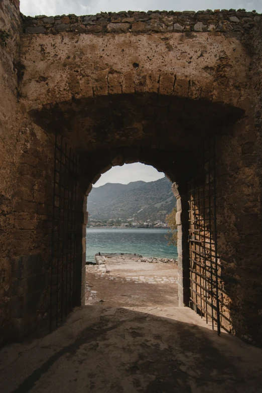 an open archway leading to the water near rocks