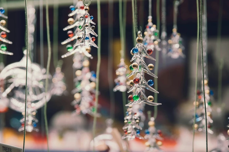 a group of glass ornaments hanging from a string