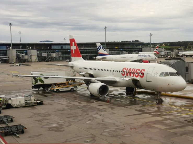 a white passenger jet sitting on top of an airport runway