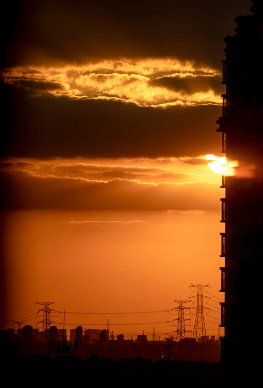 a building with wires in front of a sun