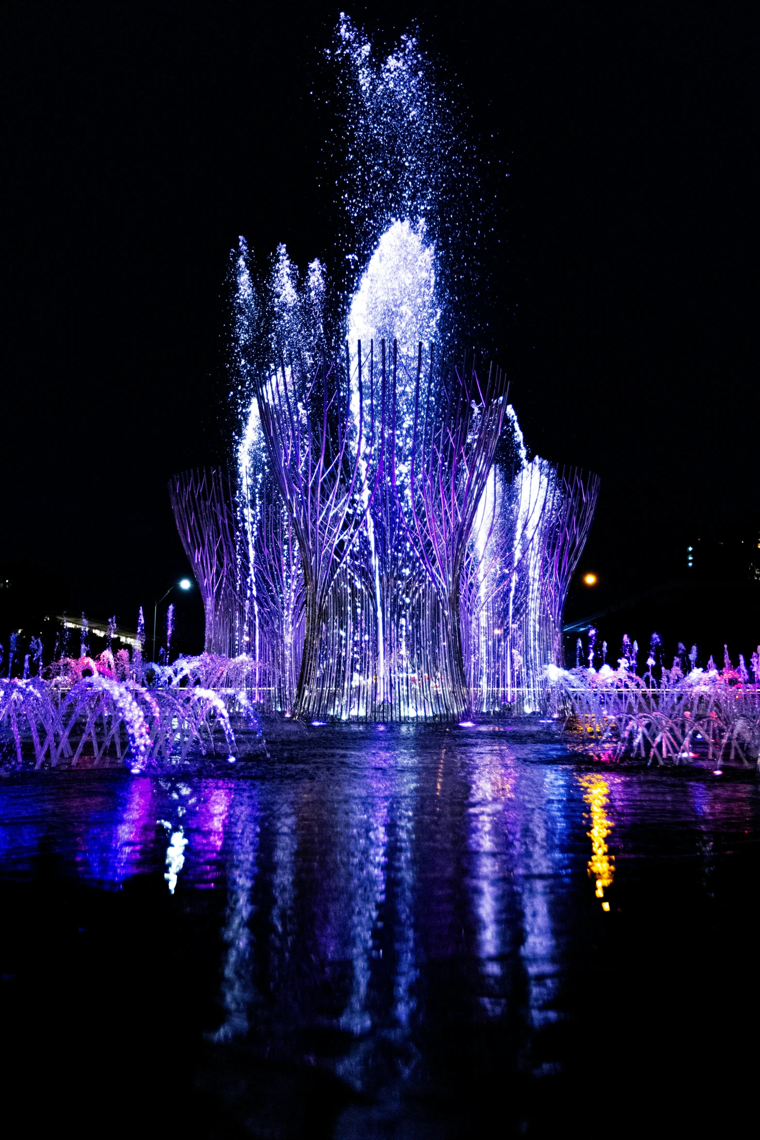 a colorful display being played on the water with multiple colored lights