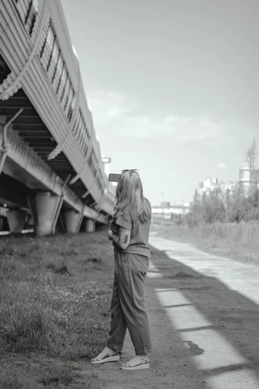 a woman standing outside of a building with a camera