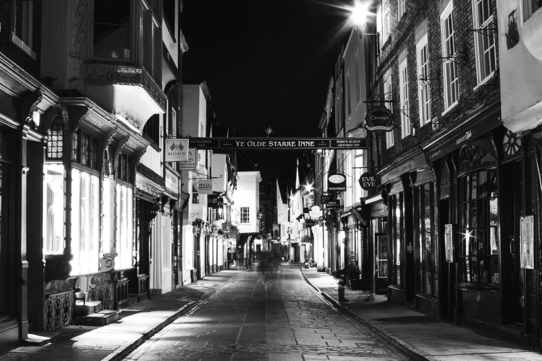 black and white po of old city street at night