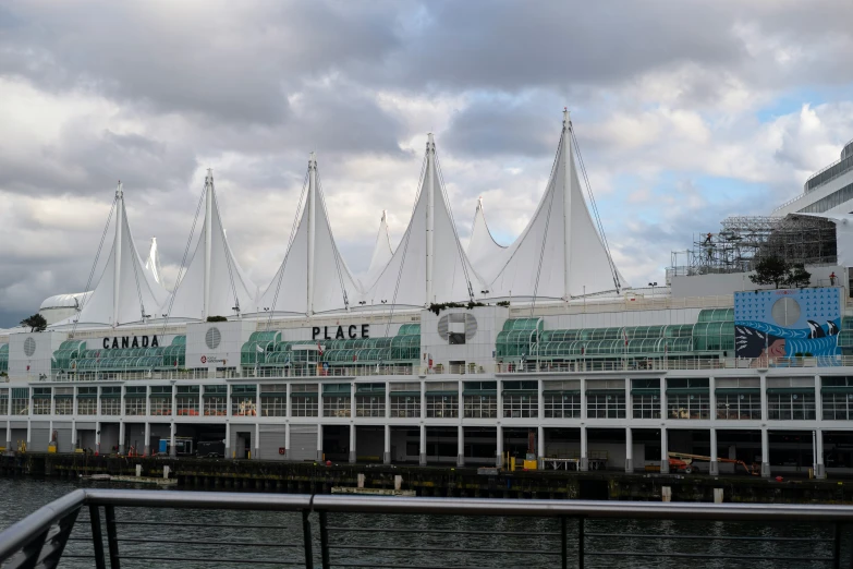 a long building with several sail boats parked in front