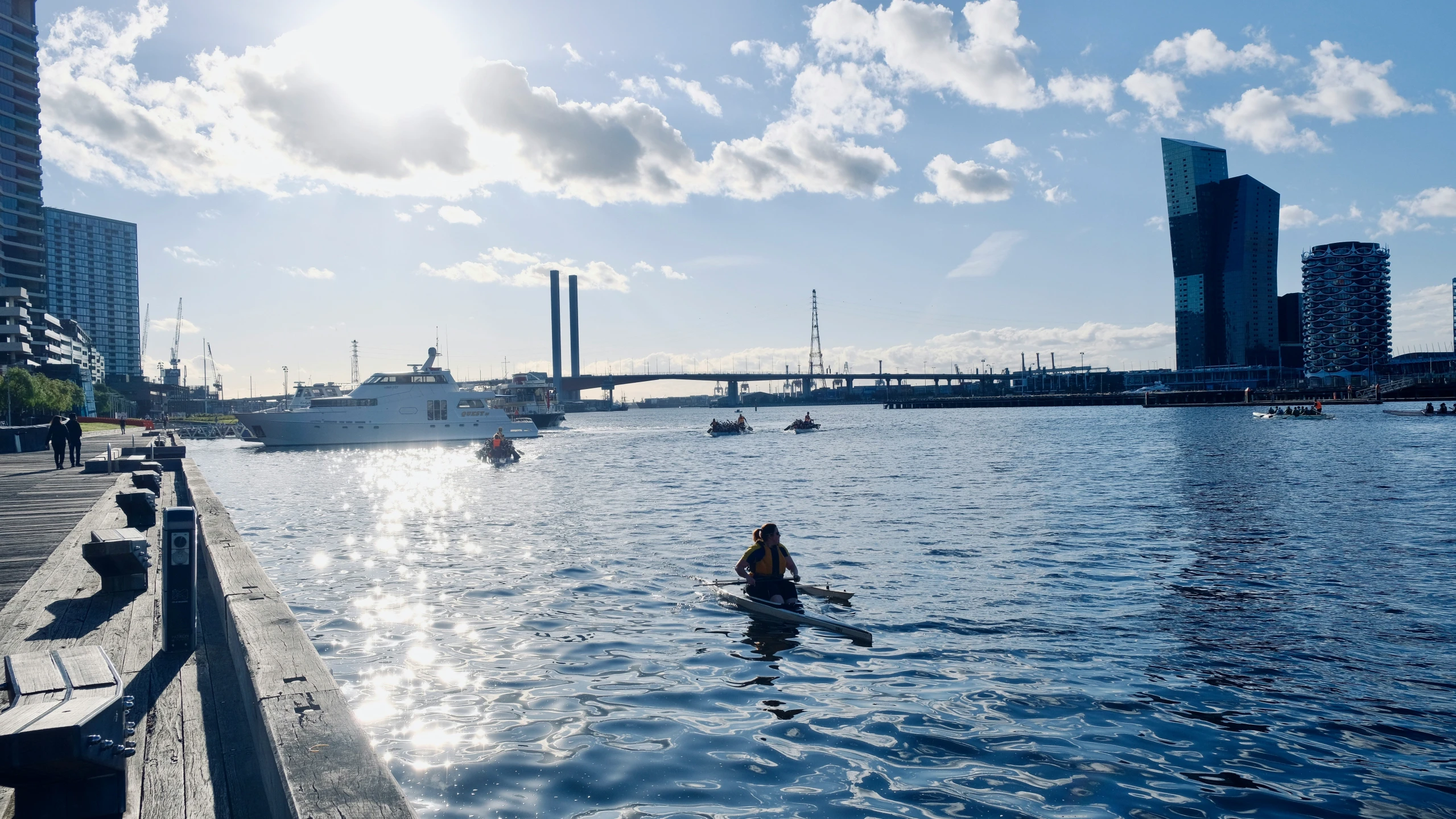 a person is sitting on the paddle board and water in the foreground