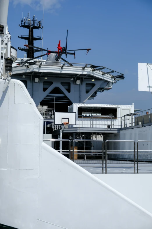 a large naval ship docked next to an airplane carrier