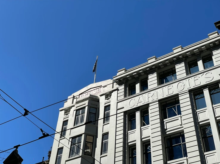 the corner of a gray building that appears to be an old fashion