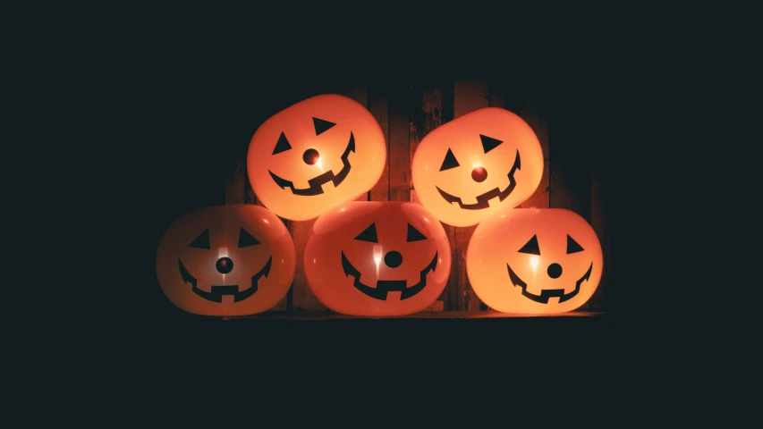 halloween pumpkins are shown on an illuminated shelf