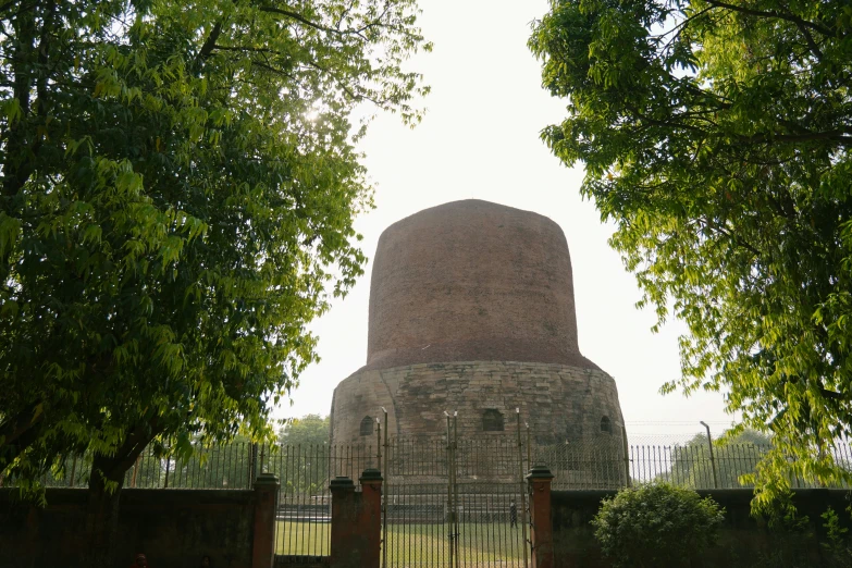 a large brick structure with trees surrounding it