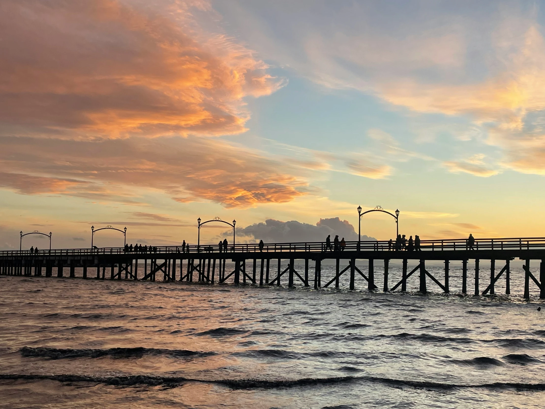 an image of people on a dock near the water