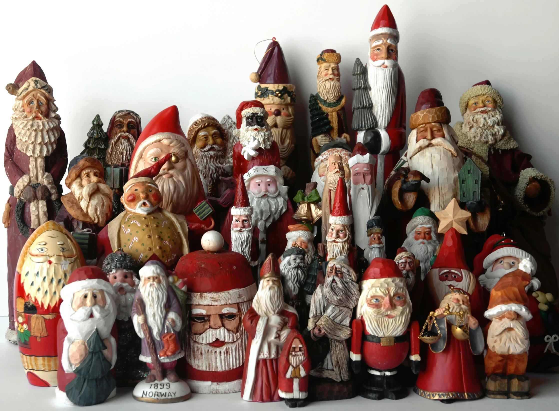 a large group of christmas santa claus figurines