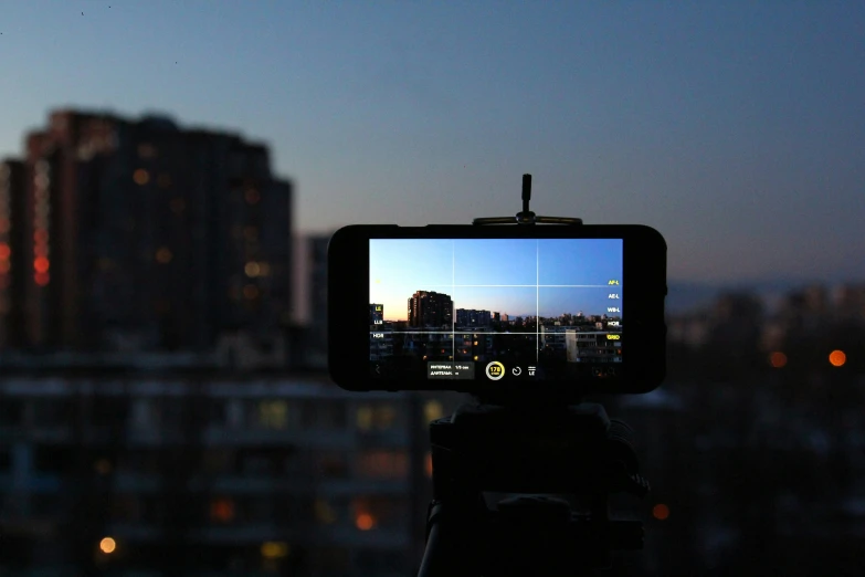 a camera showing a city skyline at dusk