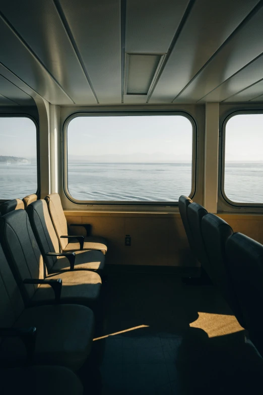 a large window on a passenger train with some empty seats