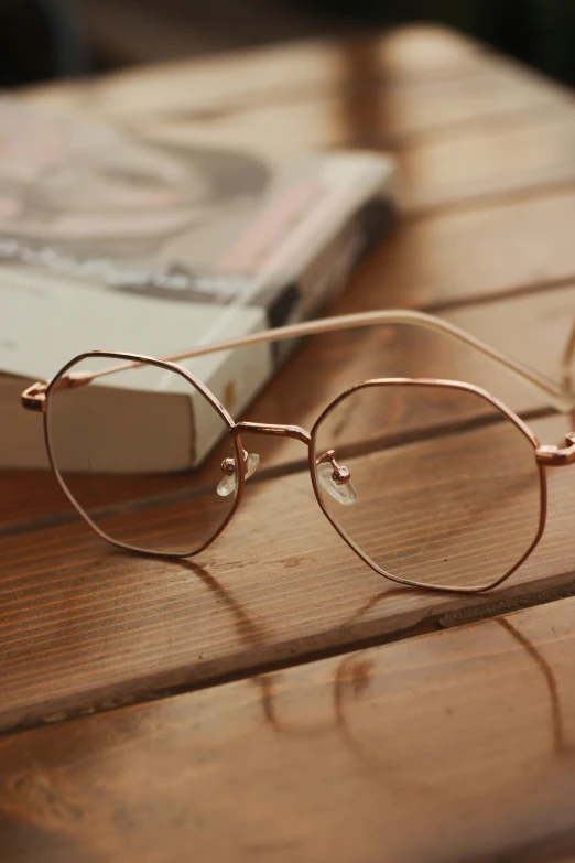 an open book and some sunglasses on a table