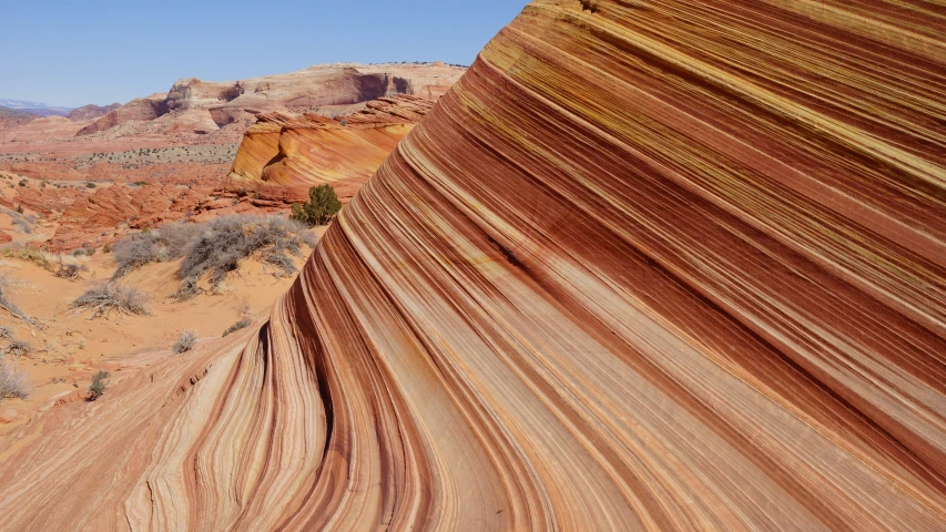 a sandy desert with steep ridges and mountains