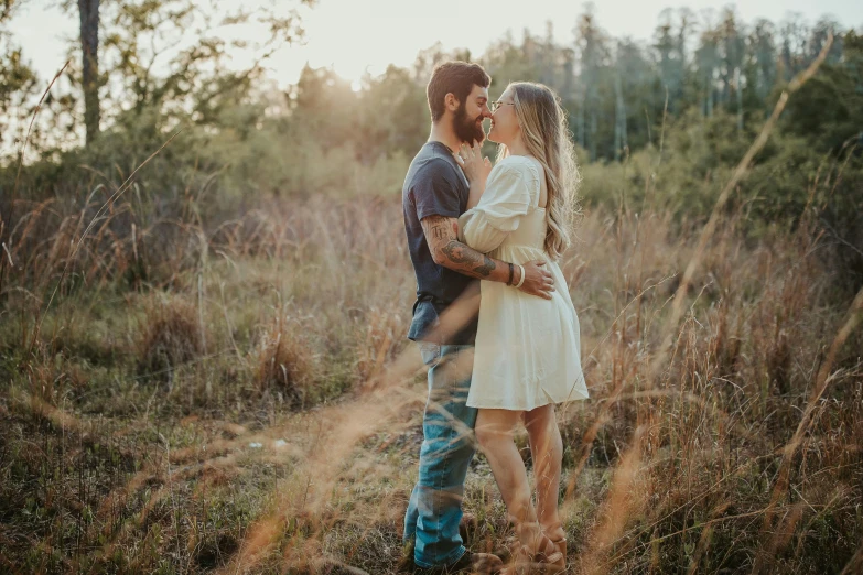 two people are standing in the grass together