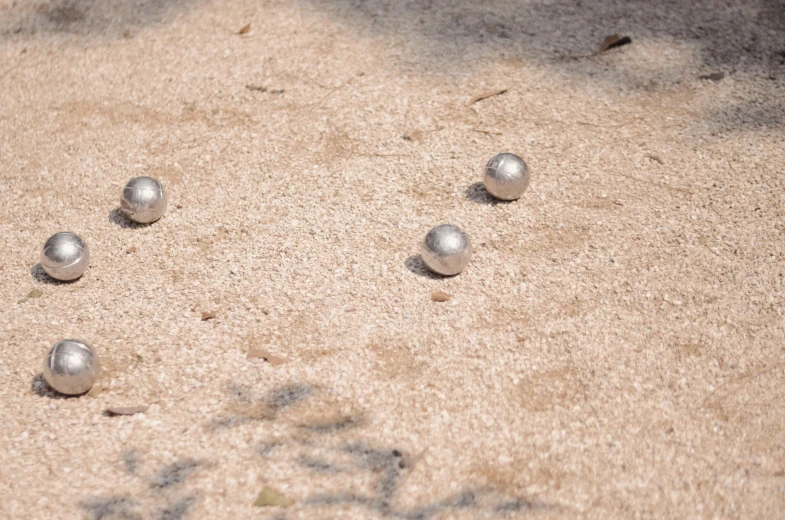 a group of balls that are on the sand