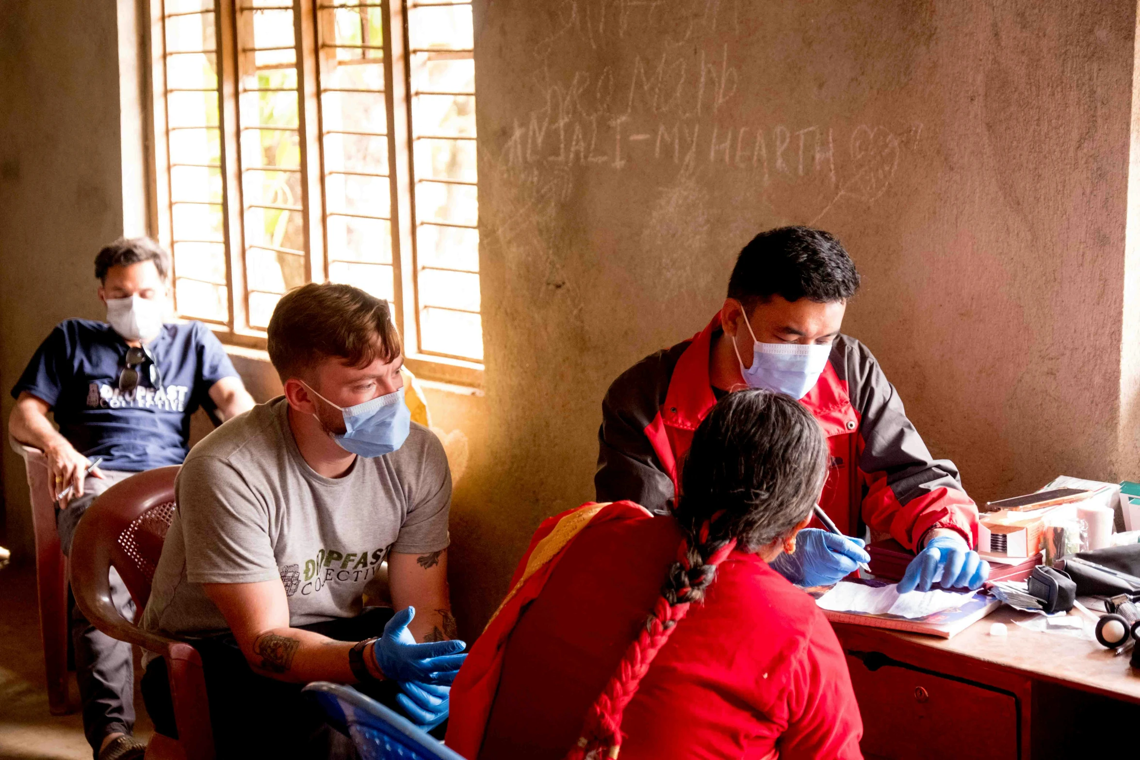 a group of people working on soing near windows