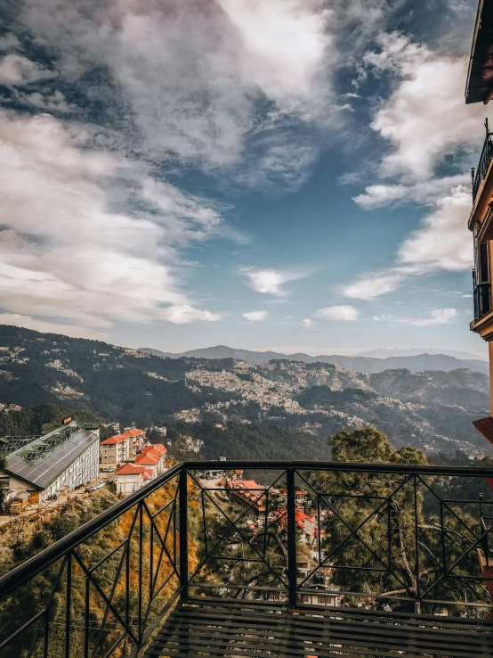 a balcony with an open door on top looking at mountains