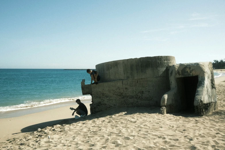 there are three people sitting on the wall of the building