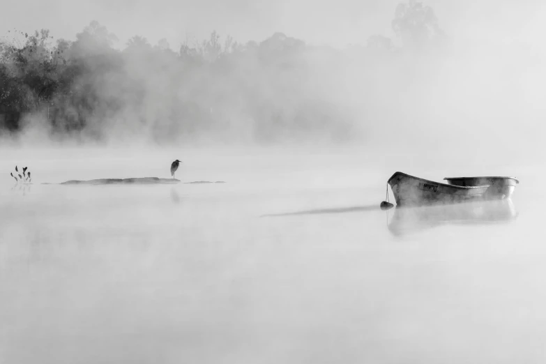 a man is walking in the water in front of two boats