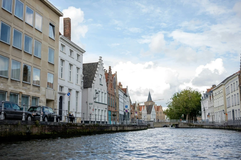 a city street with lots of tall buildings on either side of the river