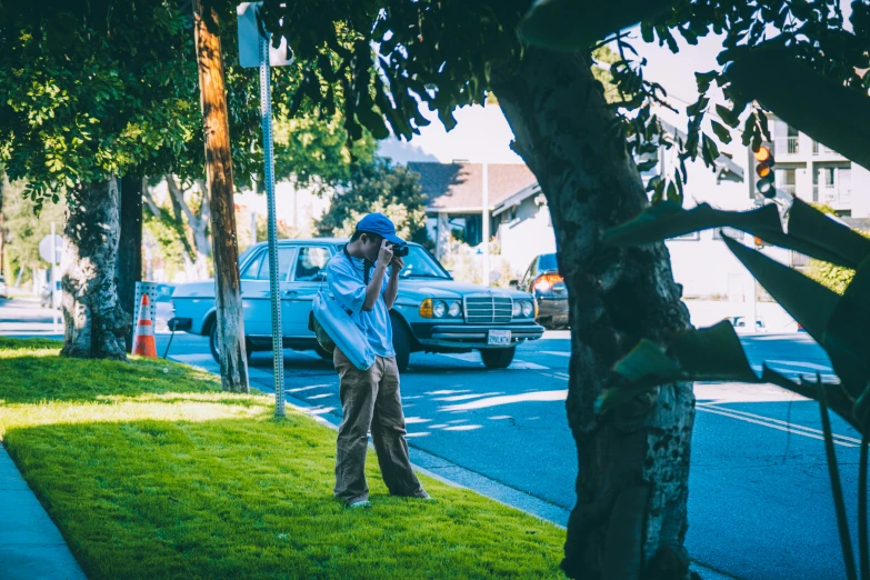 a man walking down a street while holding a book