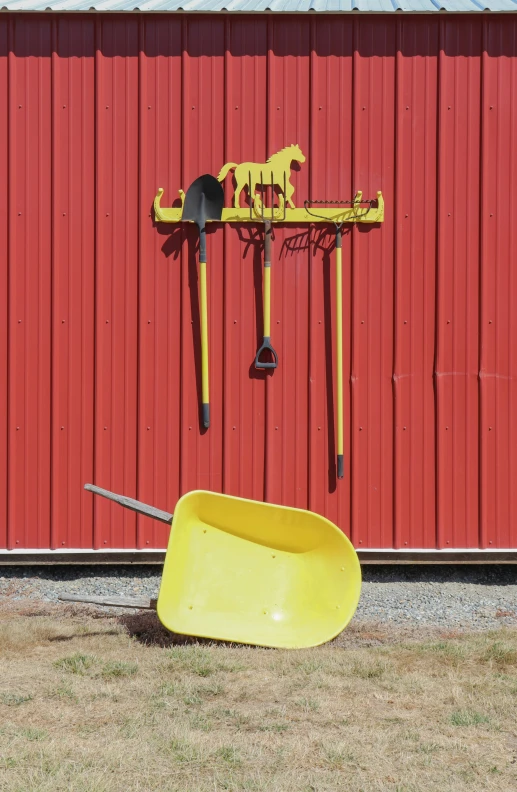 a red building with a yellow bucket and scoop