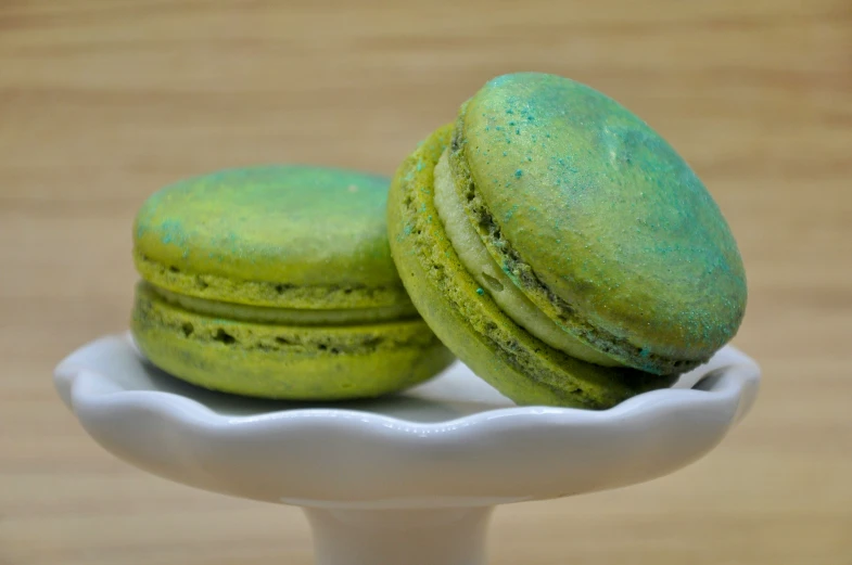 there are three green macaroons in a small dish