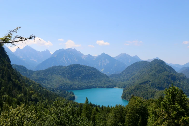 there is a blue lake in the middle of trees