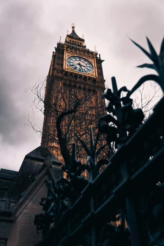 the big ben clock tower is tall and gold