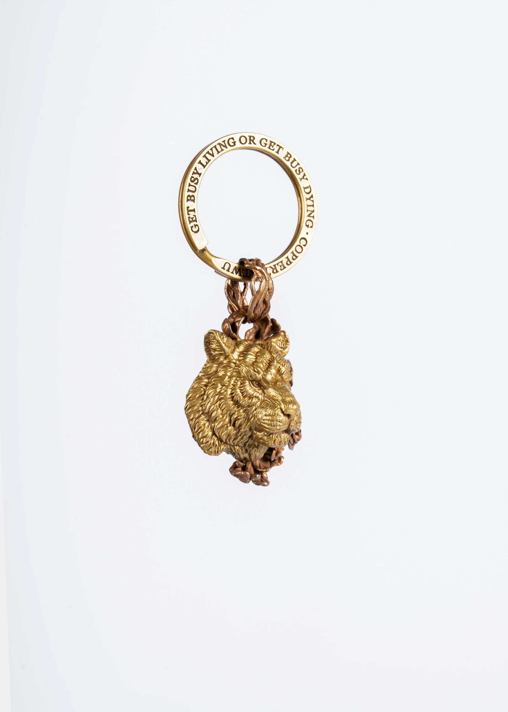 a gold key chain with two heads on it