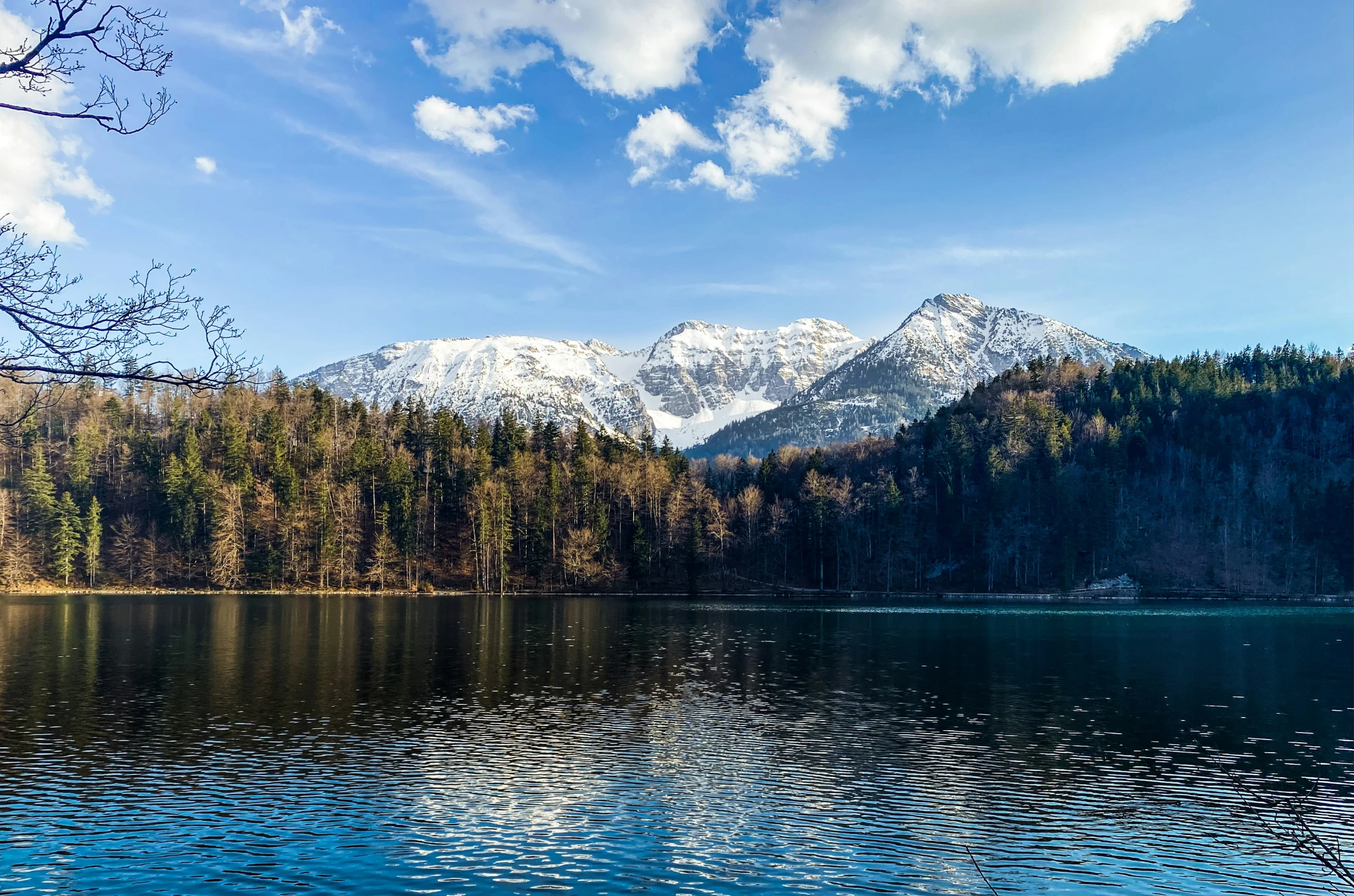 a large mountain sits next to the water