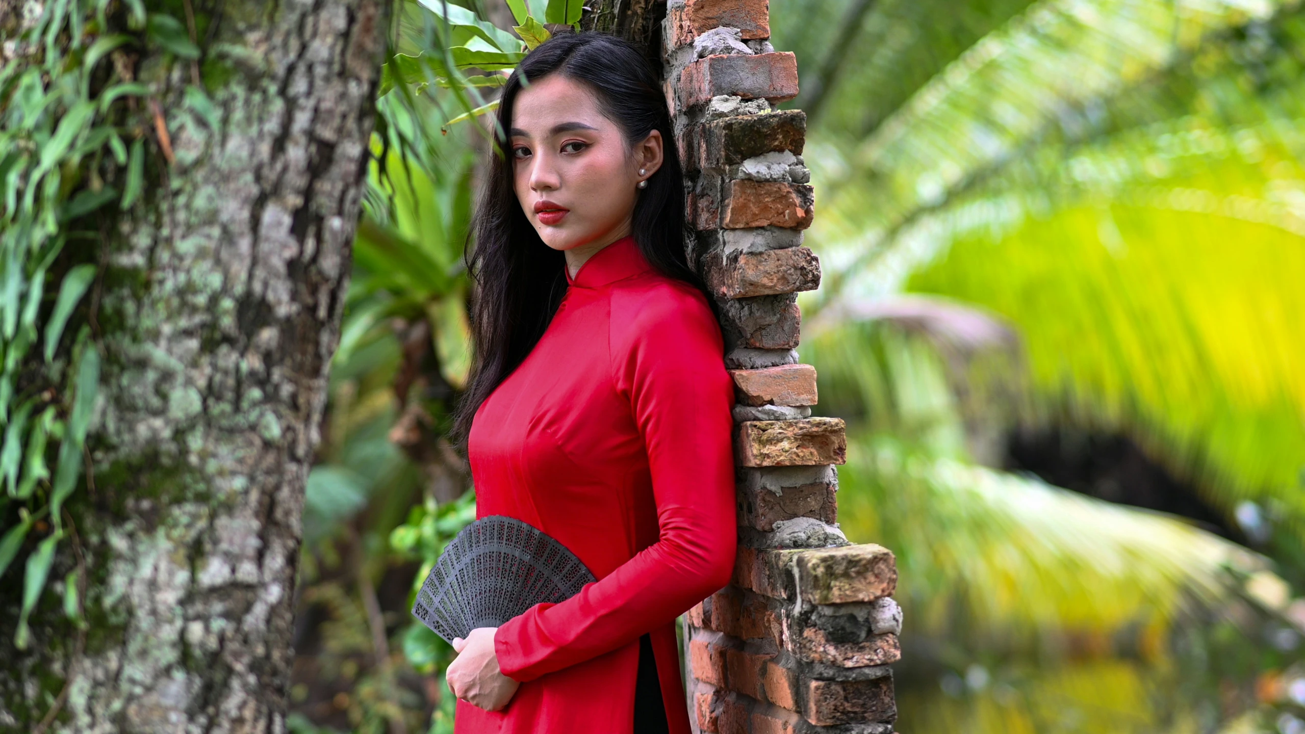 a woman with long hair wearing a red dress