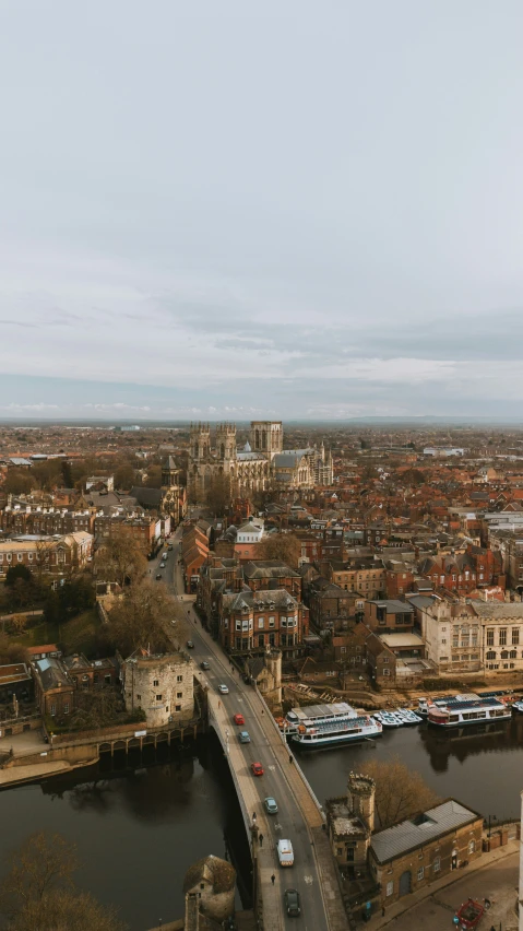 a city, looking down on a bridge that runs across a river