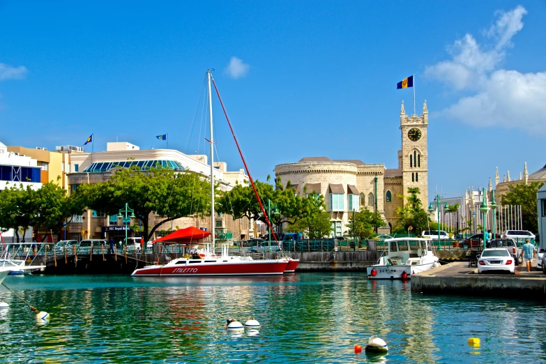 boats docked on a river and buildings in the background