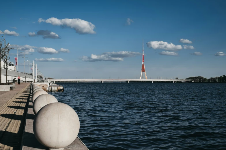 the pier is lined with long white concrete poles