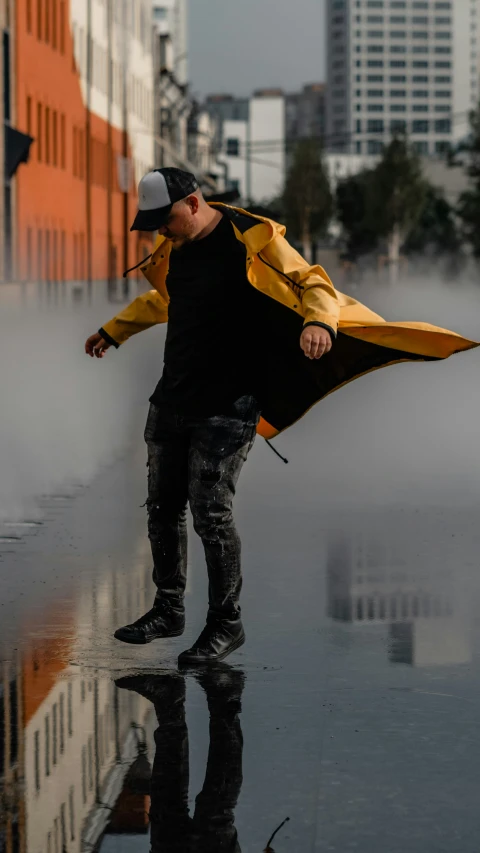 a man holding onto a yellow and black umbrella
