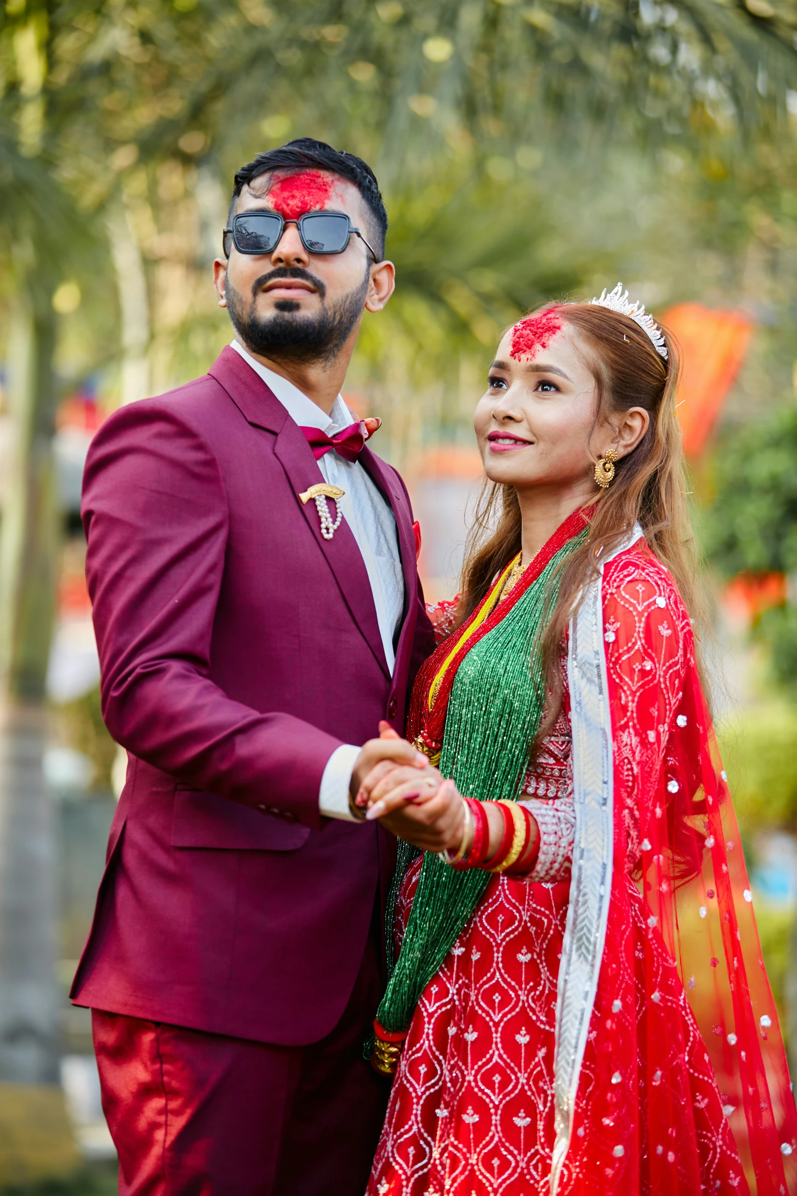 young couple dressed in traditional attire posing for pograph