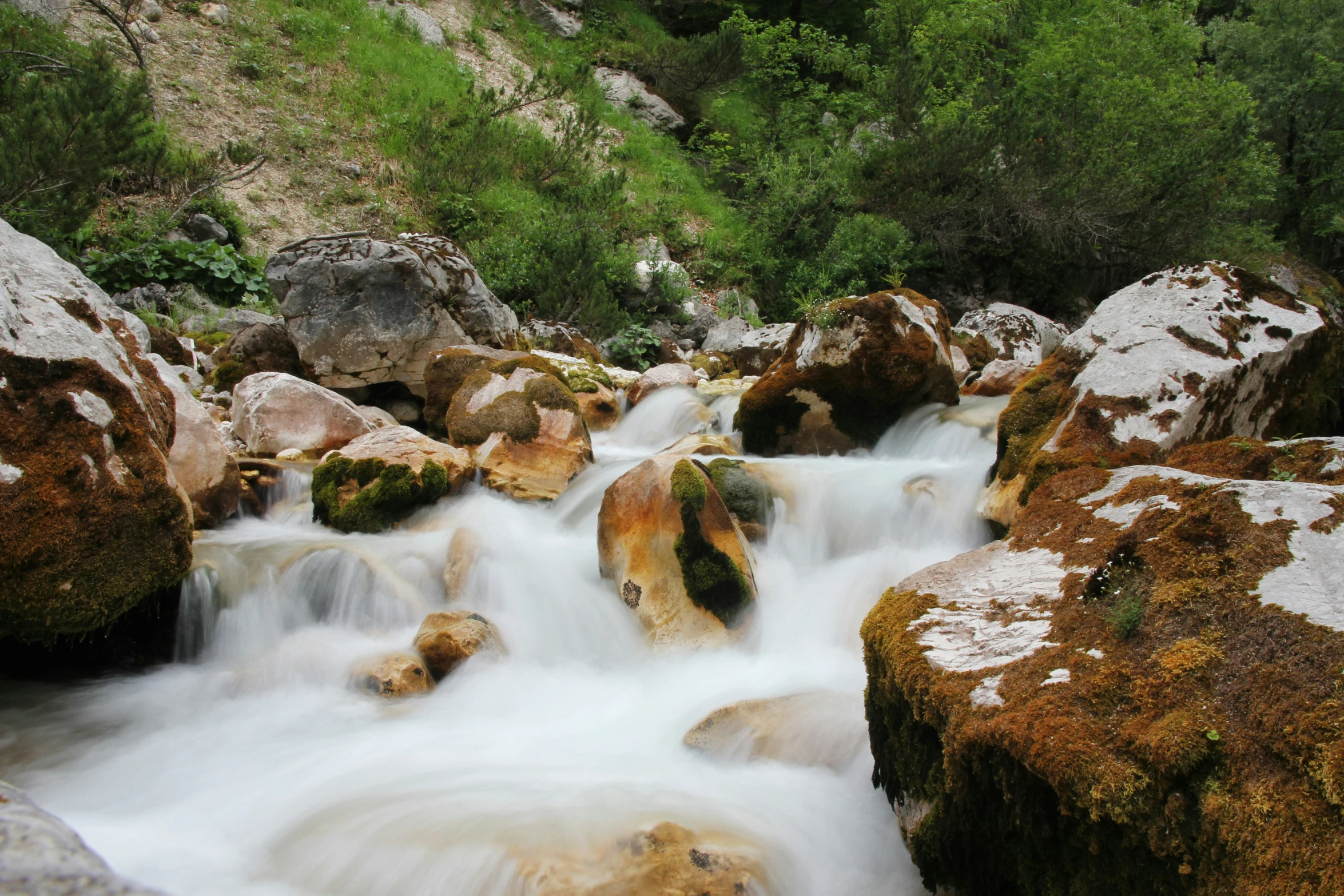 water cascading over a rock covered cliff