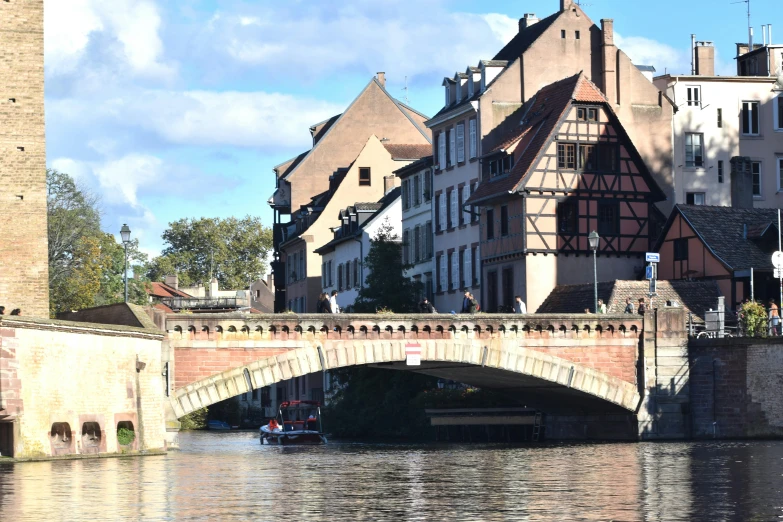 a bridge across water with buildings around it