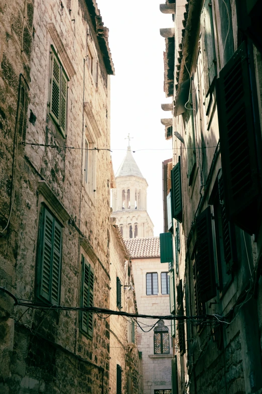 two buildings with windows that overlook an alley way