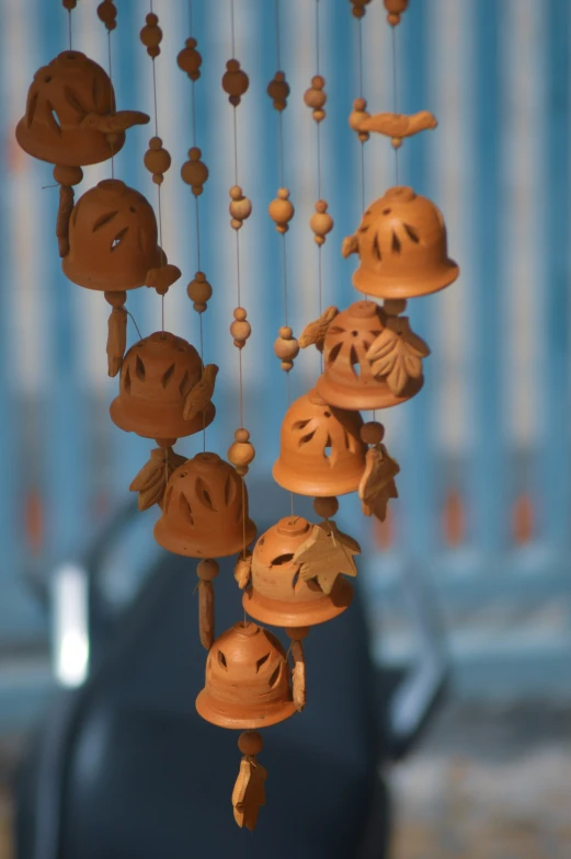 the wind chimes features a wooden smiley faces on them