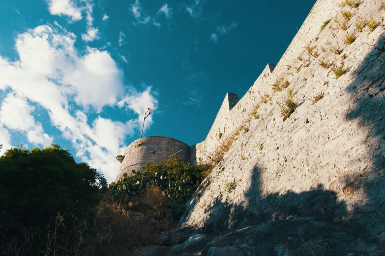 the ancient building is built into a cliff side