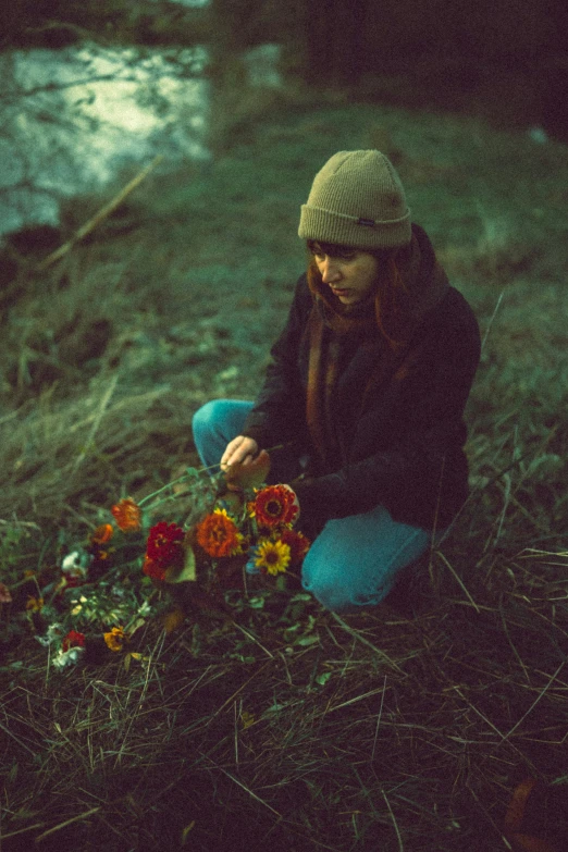 the young woman is looking for wild flowers