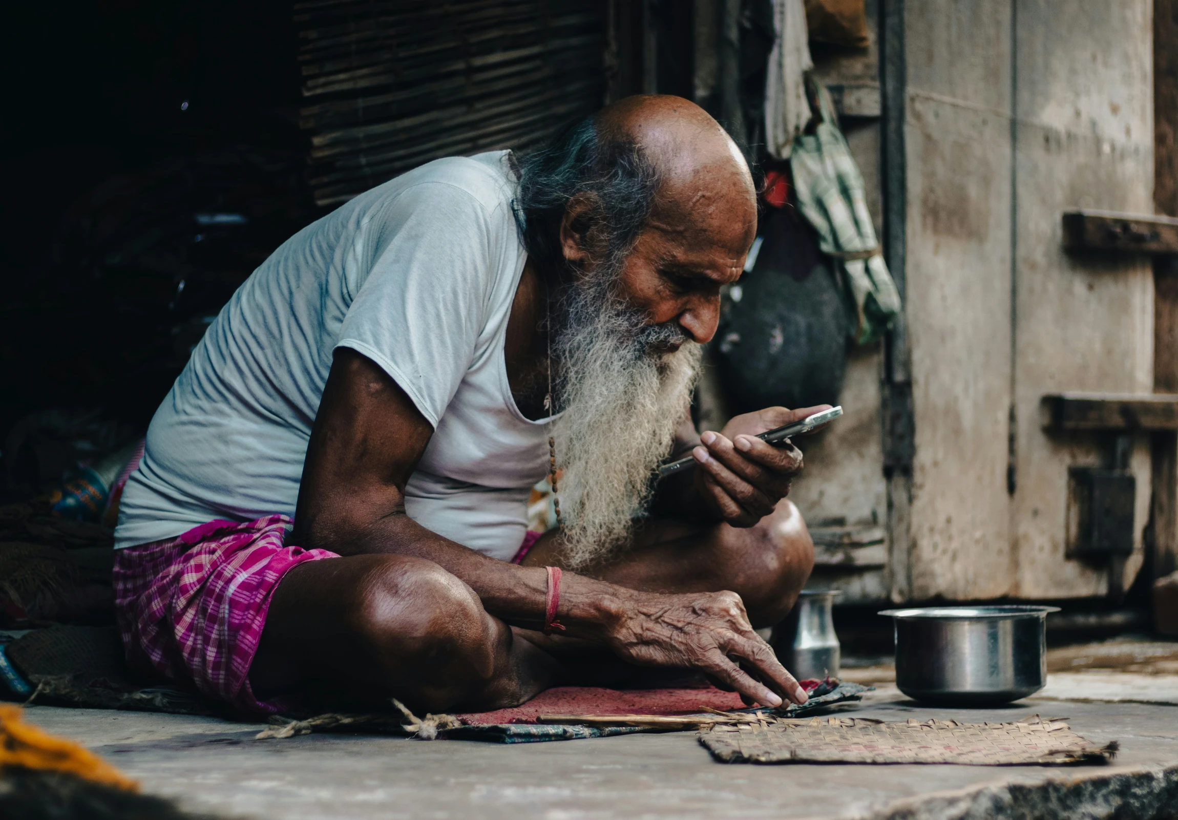 an old man is looking at his phone