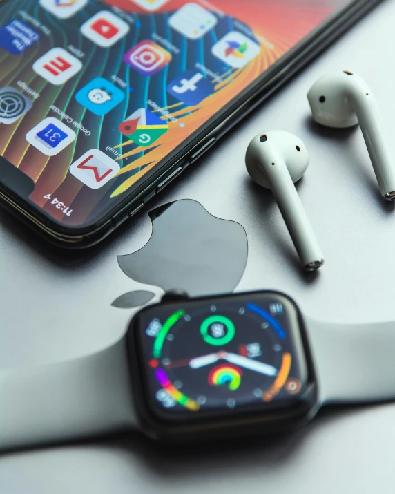 an apple watch and headphones are on the table